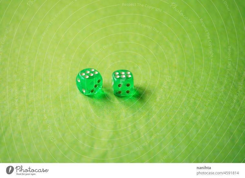 A vibrant monochromatic macro with depth of field about two green glass gambling dice with two lucky number six on green background. game bet monochrome