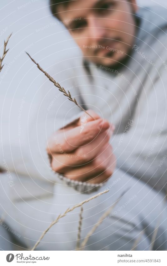 Delicate image of a young man touching nature delicate fragile new modern masculinity natural male real people lifestyle detail concept silence quiet patience