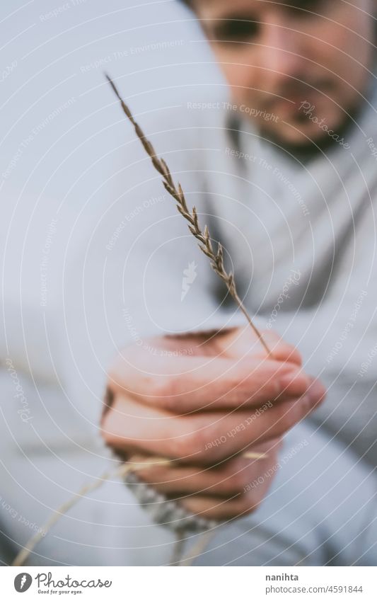 Delicate image of a young man touching nature delicate fragile new modern masculinity natural male real people lifestyle detail concept silence quiet patience