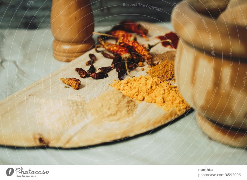 Still life of exotic and hot spices spicy indian arabic tumeric ginger powder pepper chilly ingredient garlic nutmeg cayenne tasty art artistic rustic rural