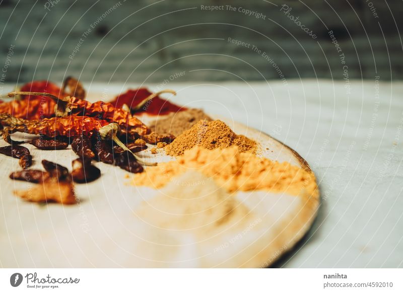 Still life of exotic and hot spices spicy indian arabic tumeric ginger powder pepper chilly ingredient garlic nutmeg cayenne tasty art artistic rustic rural