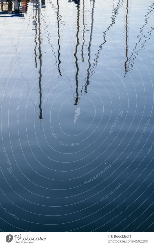 Reflection of masts of sailing boats on the water Deserted hazy Blue Reflection in the water Water Lake Vacation & Travel Maritime Rotated Inverted Sailing trip