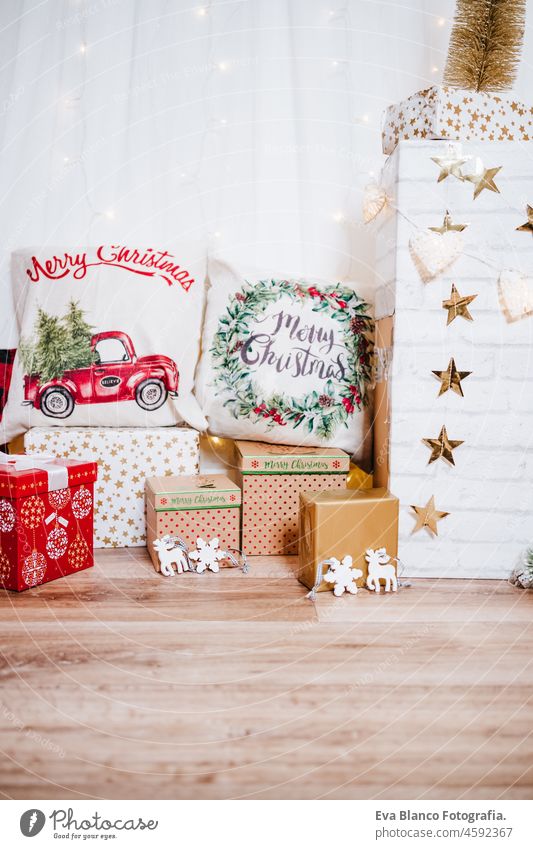 beautiful christmas decoration at home. Chimney, gifts, tree, noel, cushions on beautiful indoor white studio. Christmas concept. Nobody chimney evening bright