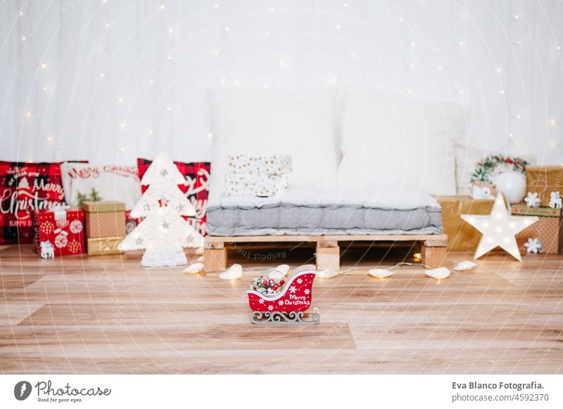 beautiful christmas decoration at home. Chimney, gifts, tree, noel, cushions on beautiful indoor white studio. Christmas concept. Nobody chimney evening bright