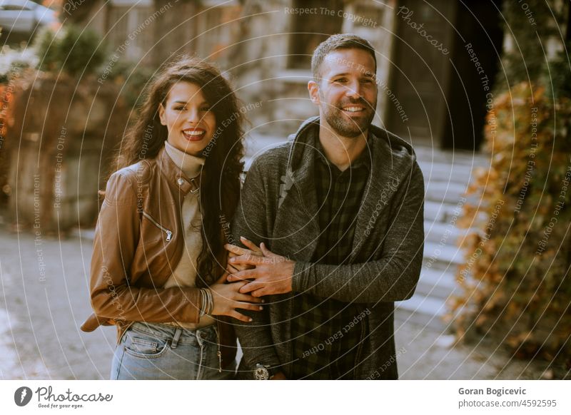 Young couple walking in autumn park adult beautiful beauty casual caucasian colors couple autumn couple having fun couple outdoors couple park dating fall