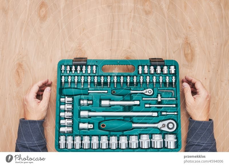 Man preparing tools in workshop. Wrench, spanner and ratchet with many attachments repair engineering mechanic repairing measuring calliper toolbox industrial