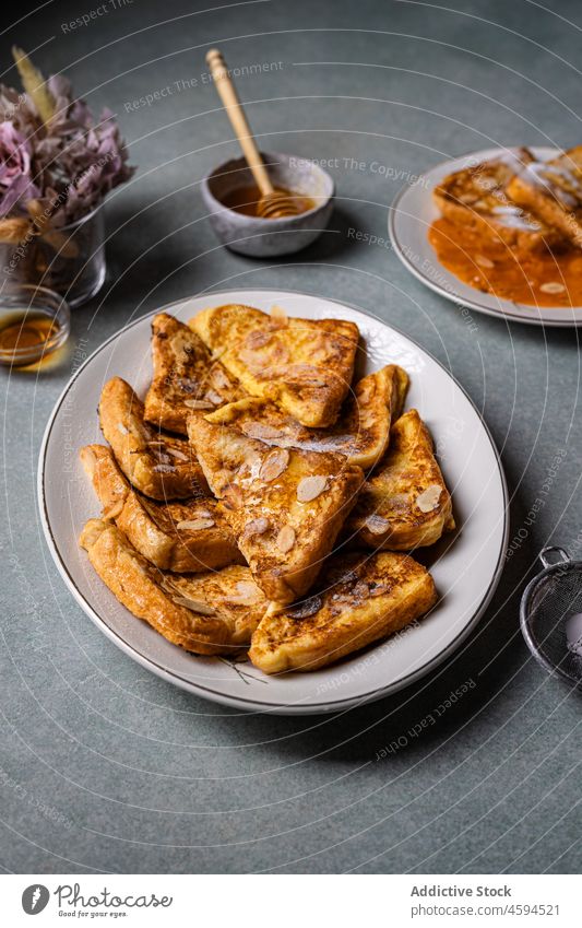 Delicious French toasts placed on table person tasty delicious yummy honey bowl portion morning plate dish food nutrition sweet bread appetite healthy food