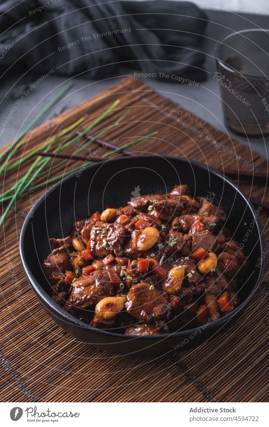 Bowl of delicious dish with stewed Asian chicken meal chives chopstick tradition food bowl portion chinese bamboo cuisine asian food dinner almond vegetable