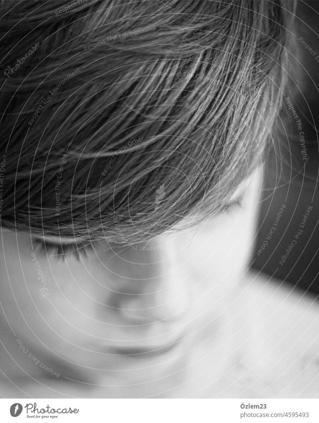 Looking down boy with side parting Boy (child) Son Child son Infancy Downward Black & white photo Hair and hairstyles portrait Close-up Face Family