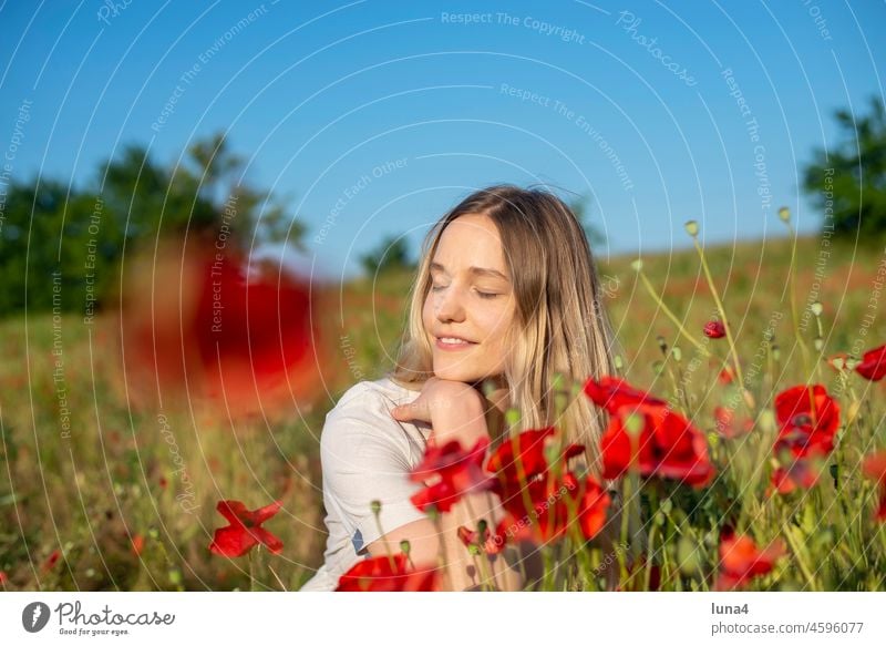 young woman enjoying sun in poppy field Woman Poppy Sun To enjoy sunbathe Smiling Laughter Young woman Poppy field sensual daintily Meadow Flower meadow