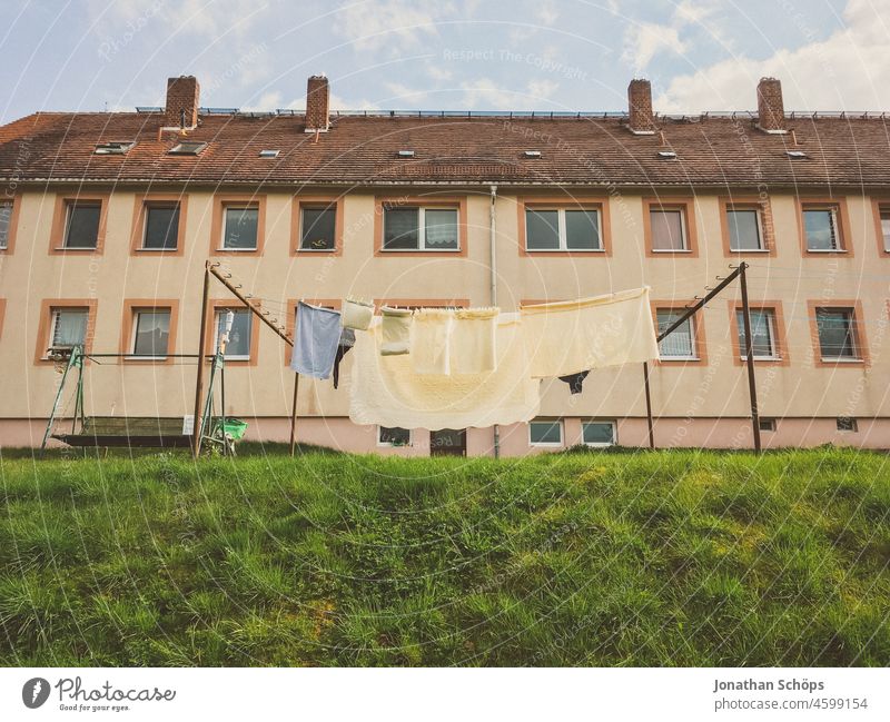 Clothesline on the lawn in front of apartment building clothesline Apartment house Apartment Building block of flats House (Residential Structure) dwell