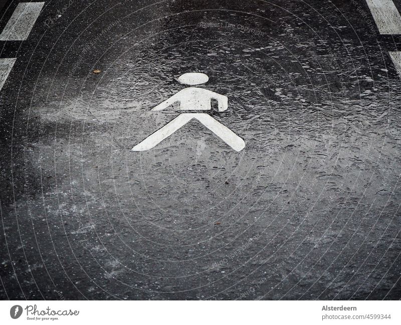 Marking signs for footpath on asphalt partly covered with a thin layer of ice Footpath mark symbol Sign for footpath Boundary Pedestrian Ice frozen ground