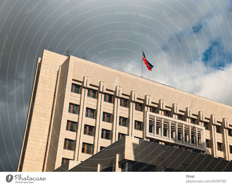 A tall building with a flag on top of it on a bright cloudy day Building Flag Tall sunny Russia Russian