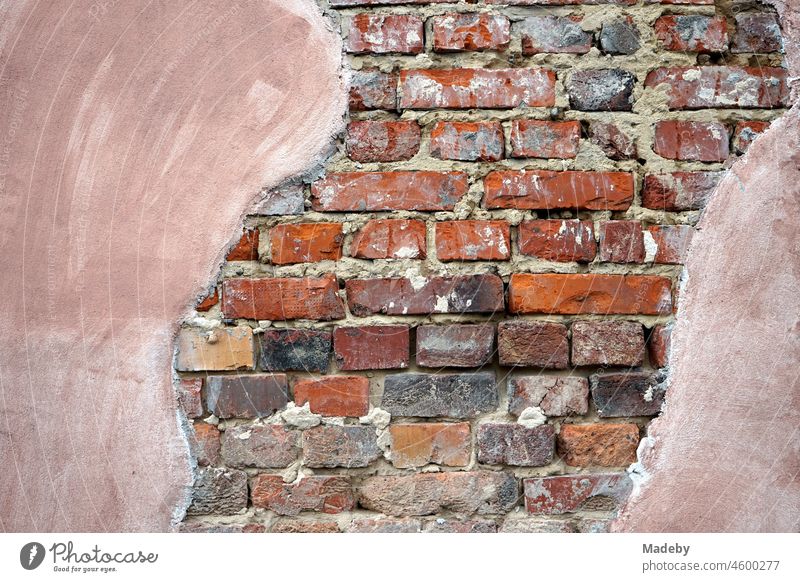 Washed-out peeling plaster on reddish-brown old brickwork of a former factory site in the Margaretenhütte district of Gießen on the Lahn in Hesse Old Retro