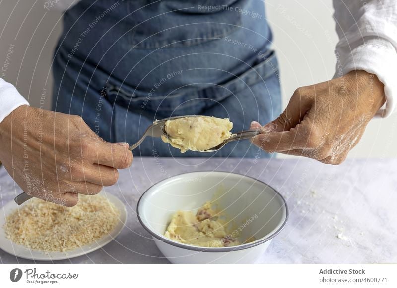 Unrecognizable man shaping potato croquette dough cook cuisine chef uncooked culinary shape delicious tasty yummy table appetizing palatable delectable food