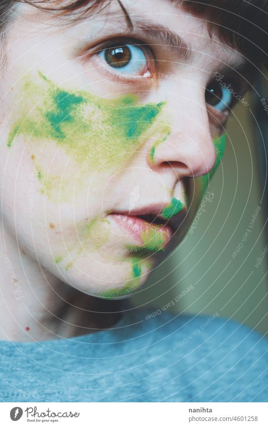 Moody portrait of a young woman with her face painted of green depression depressed hopeless emotional emotive mood intense psychology human human being natural