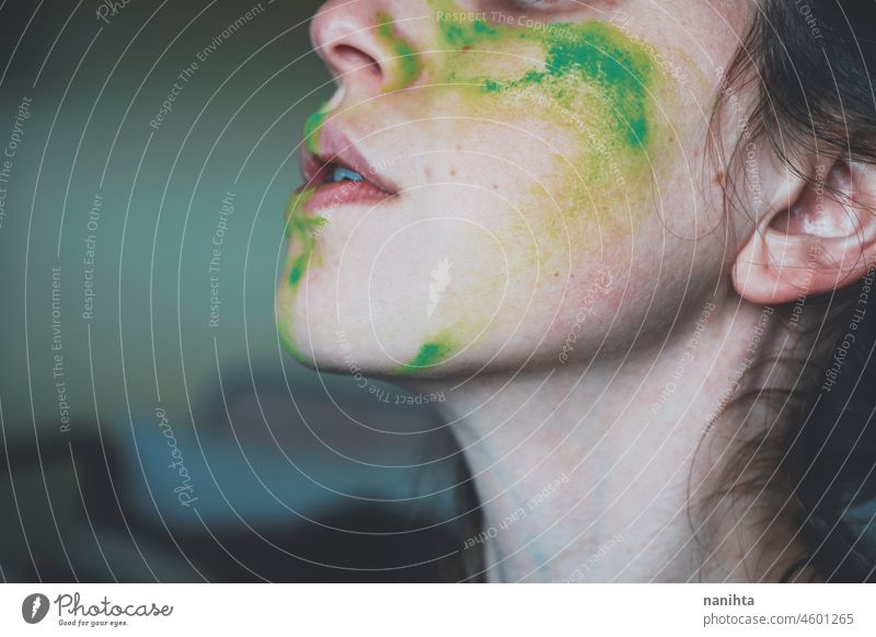 Moody portrait of a young woman with her face painted of green depression depressed hopeless emotional emotive mood intense psychology human human being natural