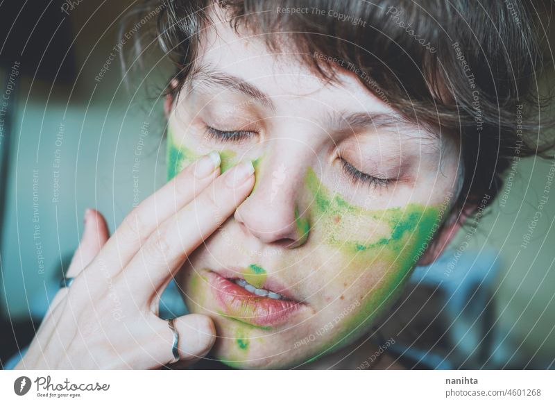 Moody portrait of a young woman with her face painted of green depression depressed hopeless emotional emotive mood intense psychology human human being natural