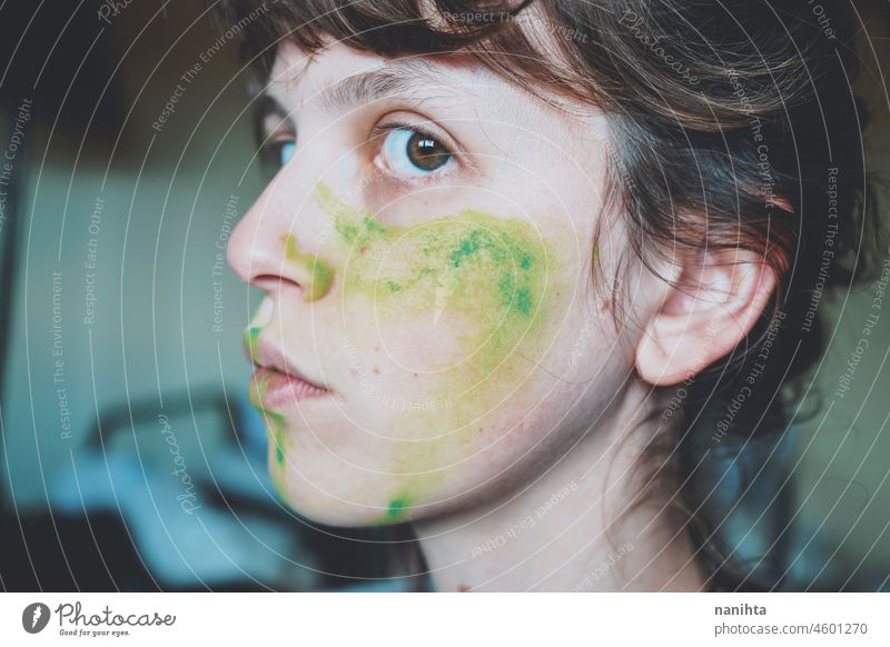 Moody portrait of a young woman with her face painted of green depression depressed hopeless emotional emotive mood intense psychology human human being natural