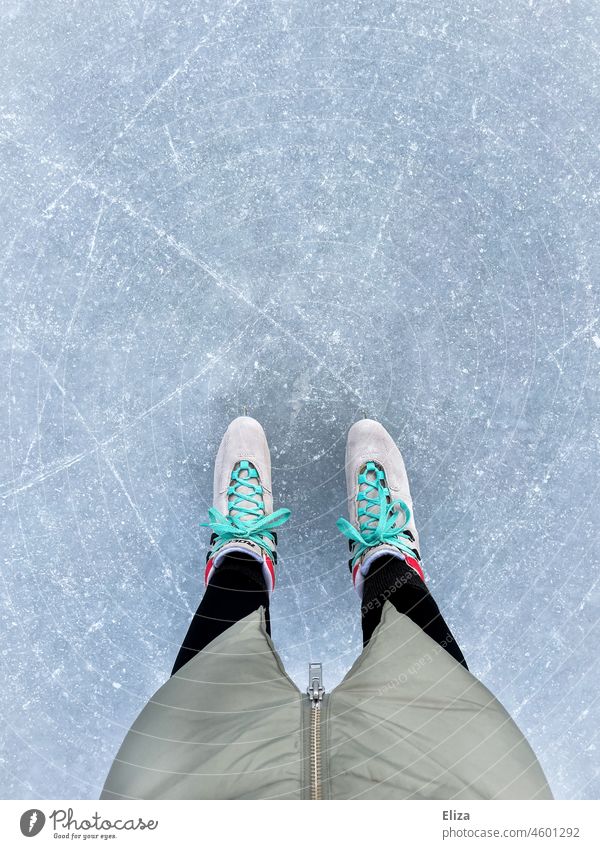 The legs of a woman with skates on a skating rink ice skating Ice-skates Ice-skating Winter Frozen surface Winter sports Leisure and hobbies ice rink Cold Woman