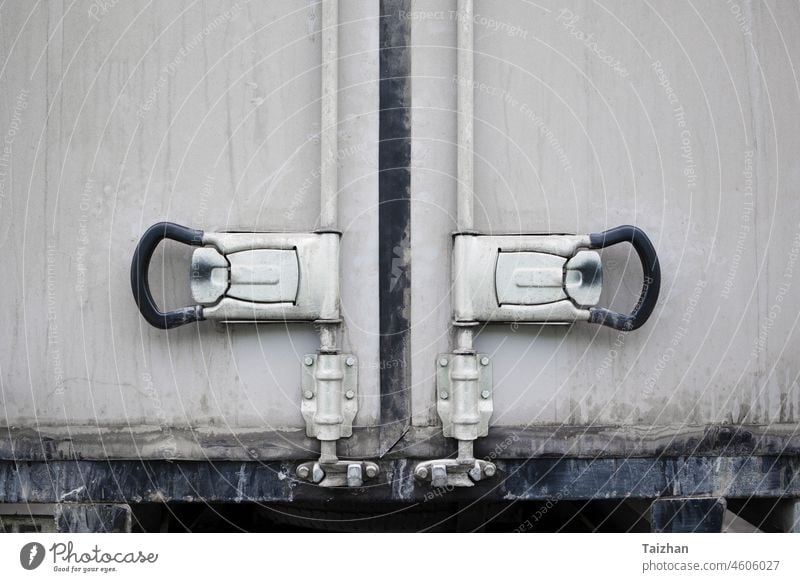 Back doors of white dirty cargo truck . Close up Handle and lock of Cargo Truck delivery shipping transport transportation van industrial industry box