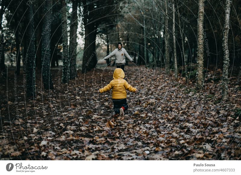 Child running to his mother childhood Mother motherhood Rear view two people Authentic Happy Infancy care togetherness Family & Relations Love Together