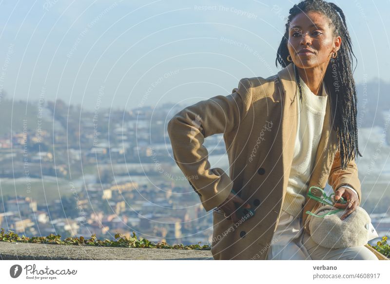 young african business woman holding glasses on a mountain landscape dreadlocks black beautiful female cheerful happy adult happiness portrait girl people