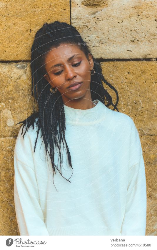 beautiful young confident african young woman over sand stones dreadlocks black female cheerful happy adult happiness portrait girl people lifestyle attractive