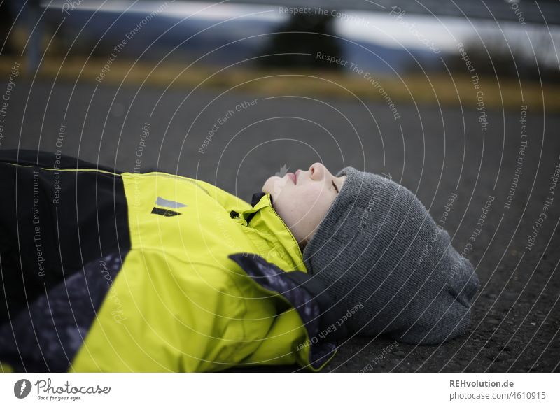 Child lying on the floor with eyes closed Boy (child) naturally Exterior shot To enjoy Human being 3 - 8 years Authentic portrait Head Infancy Lie Moody