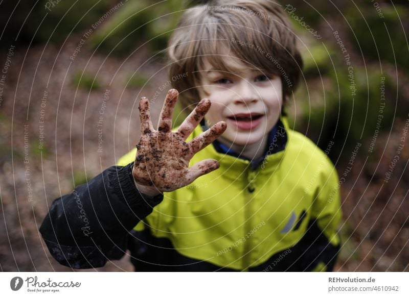 Child holding a dirty hand in the camera Boy (child) Playing Human being Joy Weather Infancy Creativity Nature Environment Earth Sand Leisure and hobbies Forest