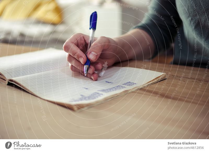 Work from home. Close-up of female hands doing calculations and working notes in a notebook. closeup planning budget money workspace holding hands accounting