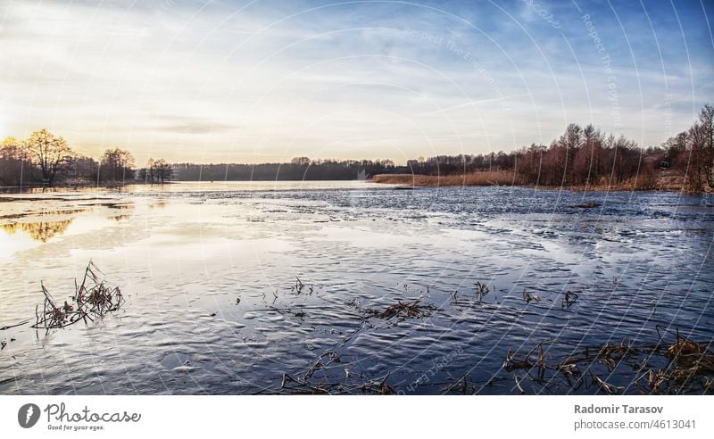 winter lake at sunset cold nature landscape ice sky water outdoor blue white cloud frost tranquil weather tree sunlight beautiful dusk natural scene climate icy