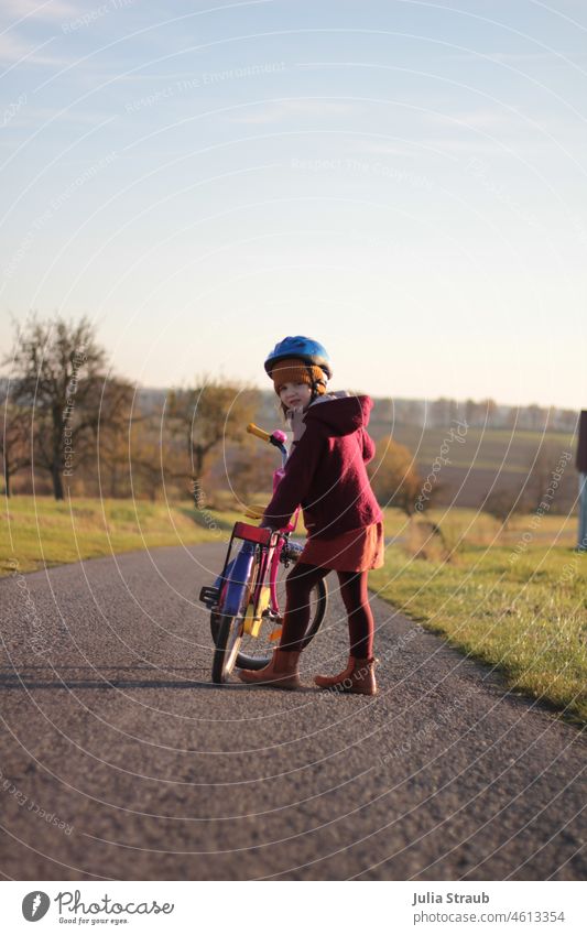 Girl waits that she can go with her bike Autumn Autumnal Street Helmet Bicycle Cycling Oldschool Bike helmet Ecological Boots Cap Landscape in the country