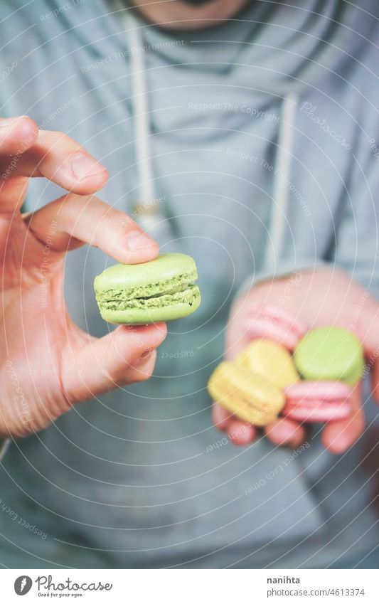 Man holding macarons in his hands macaroons temptation dessert sweet man food male delicious cuisine gourmet unhealthy sugar french variety mix many stylish