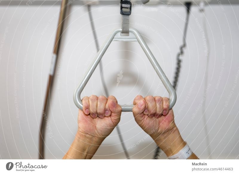 Sick man holds on to bed gallows bed erector 60-70 years Age retirement home one person detail color photograph Healthy Hospital bed stop Hand Old people's home