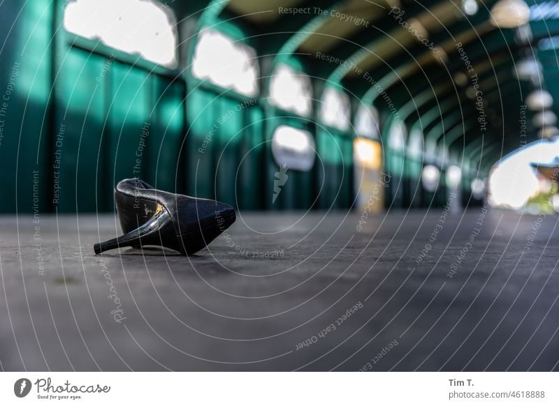 a lost lady's shoe lies on the platform Berlin Prenzlauer Berg High heels Train station Platform Subway Town Capital city Downtown Deserted Exterior shot