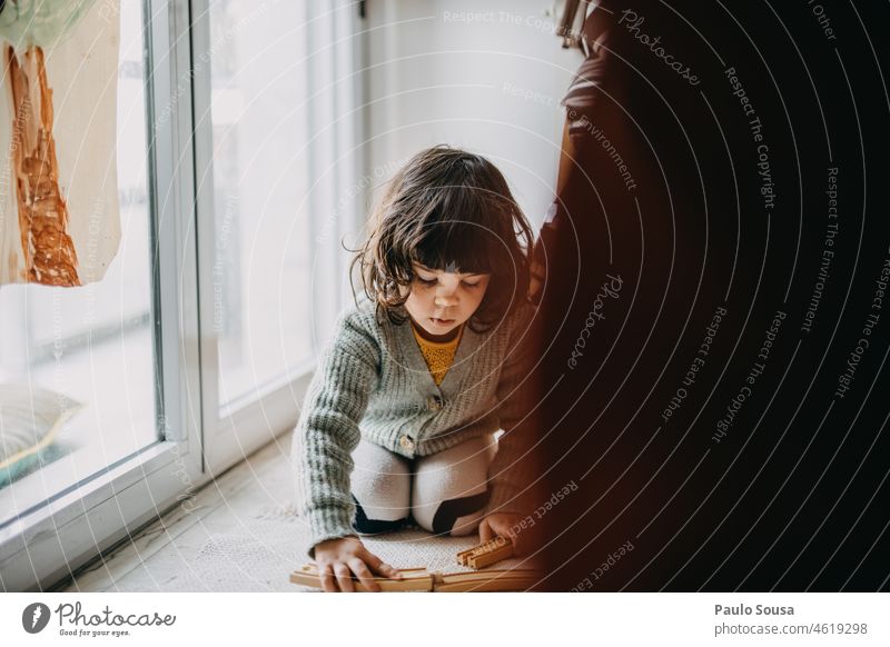 Child playing with wooden train track Girl childhood 3 - 8 years Playing Toys at home Childhood memory Leisure and hobbies Lifestyle Colour photo Joy Infancy