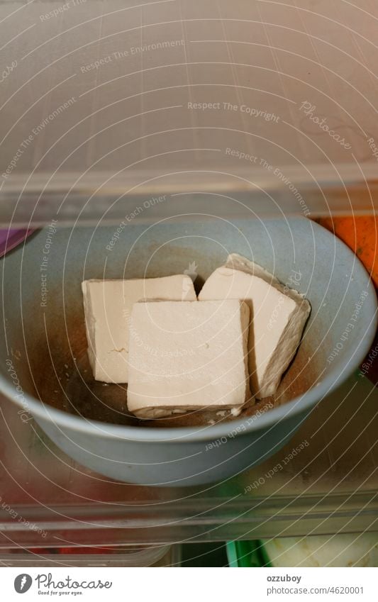 raw tofu in bowl inside refrigerator soy food protein vegan vegetarian asian fresh ingredient closeup white bean curd soybean alternative diet cube healthy