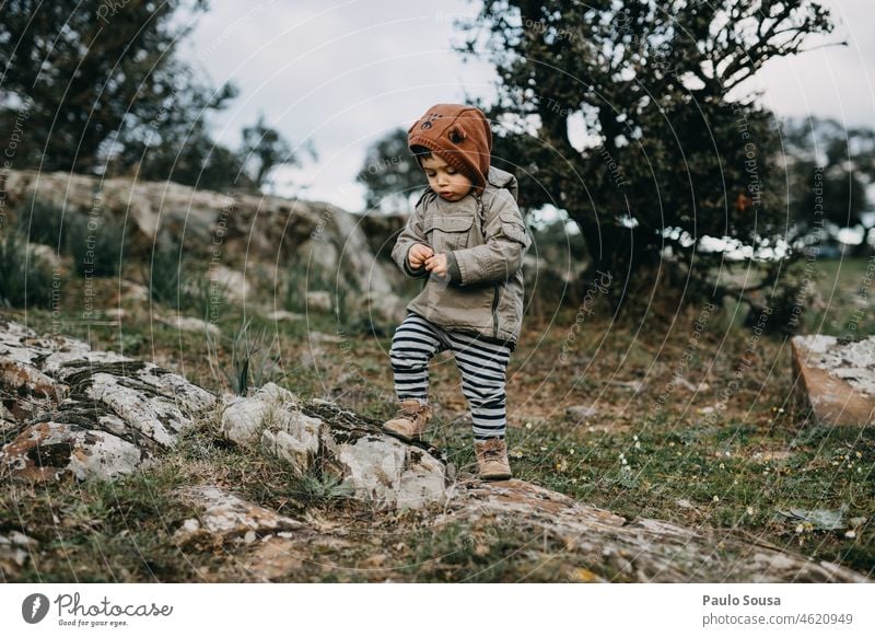 Child with Yellow hooded jacket childhood 1 - 3 years Boy (child) Caucasian Curiosity explore outdoors Environment Nature Leisure and hobbies Authentic Happy