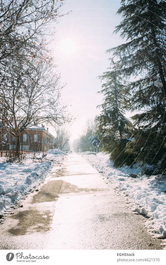 Icy road and street after heavy snowfall. Winter weather icy winter weather snowing wintertime season outdoor ice cold blizzard frost city white snowy travel