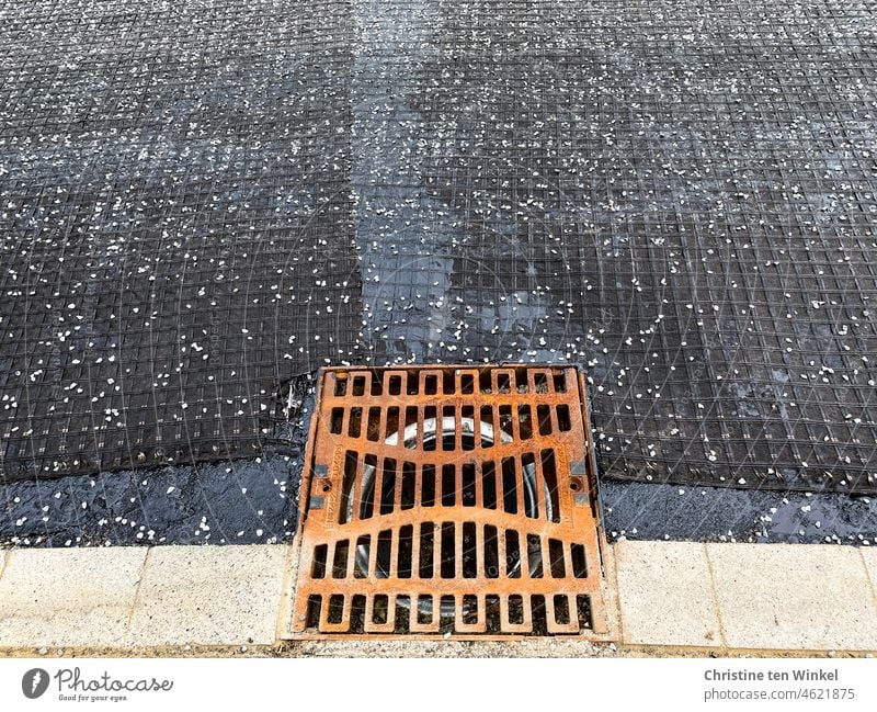 Rusty sewer grate. Road rehabilitation. The asphalt surface is still missing. Channel grille Gully Grating Street Drainage Drainage system Structures and shapes