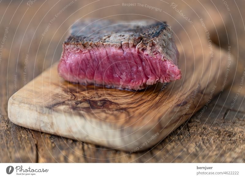 Slice of steak on wood beef steak Filet mignon Steak Meat Wood cut board medium Pink Blood Dinner sirloin Rosemary Delicious Beef grilled grilled meat roasted