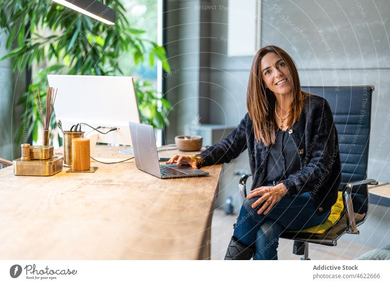 Positive woman sitting at desktop workplace style modern office portrait entrepreneur worker business job positive lady professional workspace computer female