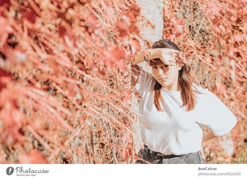 Portrait of a young redhead woman over an old white window on cool attitude, serious and confident woman, the future is woman. White shirt and modern wearing with copy space, social network concept.