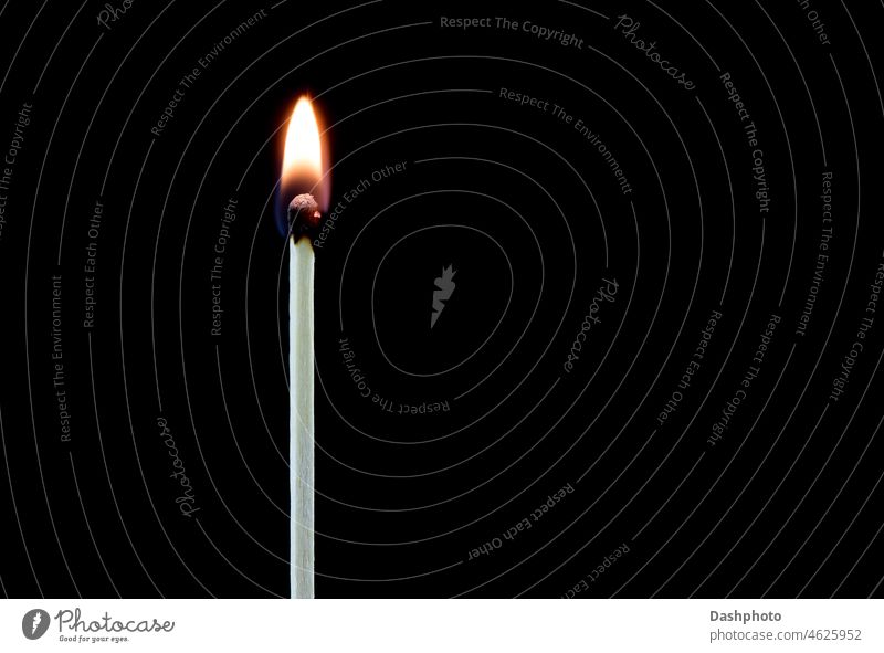 Upright Lit Match on a Black Background match lit burning ignited ignition wood wooden timber single single match flame match head glow glowing hot fire black