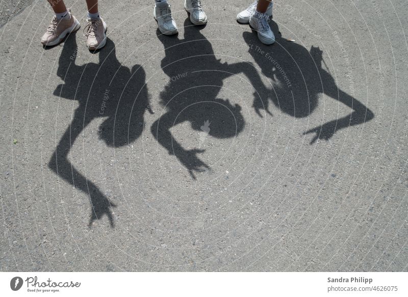 three shadows and six sneakers Shadow Exterior shot Lifestyle White Footwear Day Human being Light Contrast Feet Stand Copy Space bottom Asphalt Street Dance