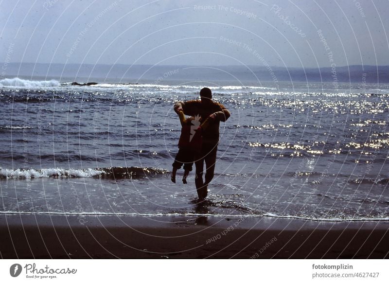 Man playing with child at sea Father Child Ocean Playing in common Considerate fun Responsibility quality time Hold Father and Child Nature at the same time