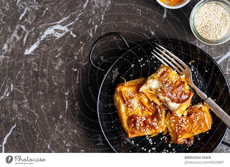 Sweet homemade pastry with sesame seeds sweet dessert culinary calorie treat food gastronomy delicious plate tasty yummy kitchen flavor fork delectable crispy