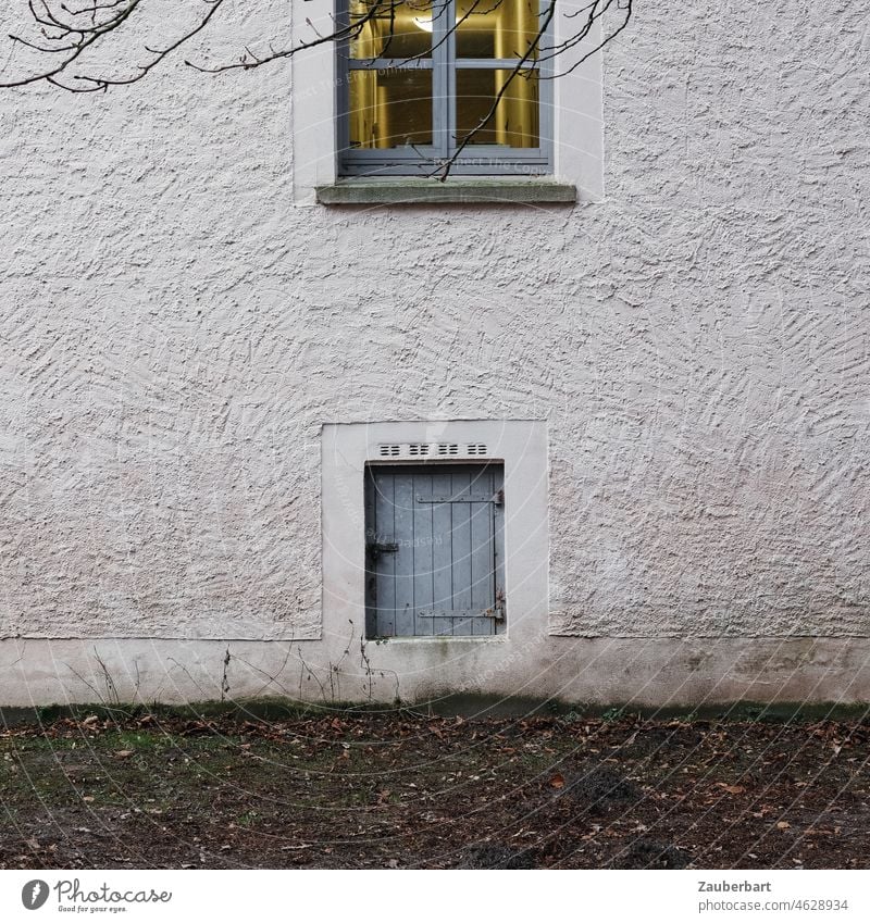 Cellar door and illuminated window on rough plastered wall Window Wall (building) Plaster roughcast Gray locked Entrance cellar entrance side entrance Small