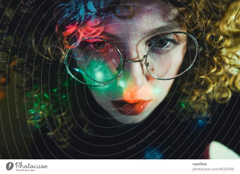 Young woman portrait illuminated by psychedelic lights retro neon party curly hair night pub alone lonely face proyector artistic creative neon lights